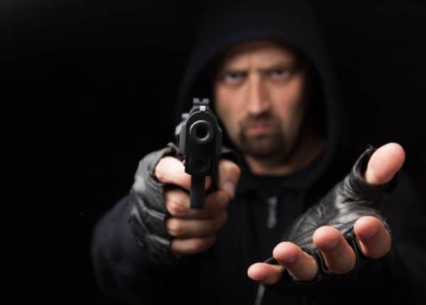 Vista and San Diego Robbery Attorney With 40 Years Experience 1 A man holds a gun pointed at the camera to commit a California robbery