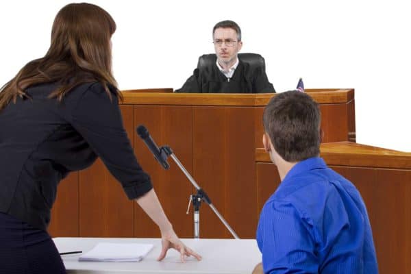 How Lawyer May be Able to Get a Confession Thrown Out of Court in Vista 1 A female lawyer talks to the judge with her client beside her.